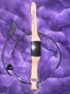 Fitbit charge 5. Tan band, and comes with charger.